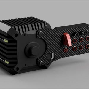 May include: A black and silver electronic device with a carbon fiber panel. The device has a series of buttons and switches, including a red toggle switch and several red-rimmed buttons. The device has a rectangular, ribbed body.