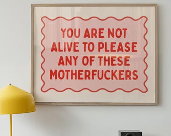 May include: A framed art print with the text "YOU ARE NOT ALIVE TO PLEASE ANY OF THESE MOTHERFUCKERS" in red on a pink background. A yellow floor lamp, a stereo receiver, and a black speaker sit on a yellow cabinet.