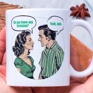 May include: White ceramic mug with a cartoon image of a man and woman talking. The woman says "Do you know any formulas?" and the man says "Yeah, sum."