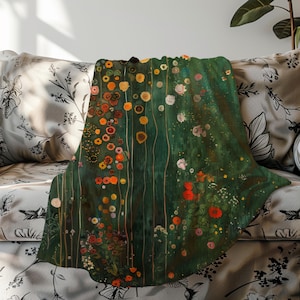 May include: A green throw blanket with a floral pattern. The flowers are in shades of red, orange, yellow, and white. The blanket is made of soft, comfortable fabric.