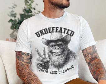 Bigfoot Unisex Tee, Sasquatch Shirt, Funny Cryptid T-Shirt, Undefeated Hide & Seek Champion, Cryptozoology Shirt, White Elephant Gift