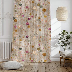 May include: A beige floral curtain with a repeating pattern of colorful flowers and thin brown stems. The flowers are in shades of purple, yellow, pink, and blue. The curtain is hanging in front of a window, with a woven lamp and a plant visible.