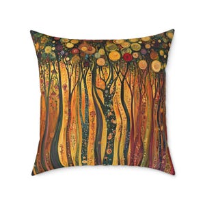 May include: A square throw pillow featuring a dense forest scene with tall, slender tree trunks in shades of orange, yellow, and dark brown. The canopy is filled with circular, flower-like patterns in red, gold, and green, creating a vibrant, textured appearance across the entire surface.
