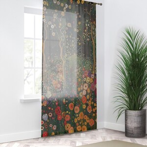 May include: Sheer curtain featuring a floral design with a dark green background. The artwork includes trees with golden trunks and a variety of colorful flowers in shades of red, orange, yellow, and white. The curtain is hanging in front of a window.