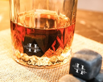 May include: A glass of amber-colored whiskey with ice cubes in a cut-glass tumbler. The ice cubes are engraved with the letter "H" and the word "HELEN".