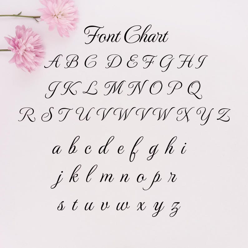 May include: A font chart displaying uppercase and lowercase letters in a cursive script. The text "Font Chart" is at the top. Pink flowers are in the upper left corner. The background is a light pink color.