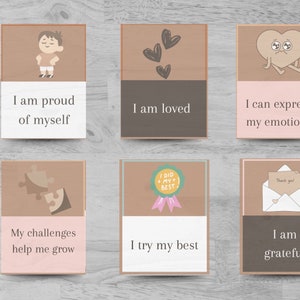 Peut inclure: Ensemble de six cartes d'affirmation avec illustrations et texte. Les cartes sont brunes avec des accents roses. Le texte sur les cartes comprend : "Je suis fier de moi", "Je suis aimé", "Je peux exprimer mes émotions", "Mes défis m'aident à grandir", "Je fais de mon mieux", et "Je suis reconnaissant".