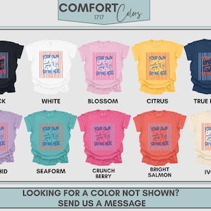 May include: A collection of ten short-sleeve t-shirts in black, white, blossom, citrus, true navy, orchid, seaform, crunch berry, bright salmon, and ivory. Each shirt features a central graphic with vertical stripes and the text YOUR OWN mah jong SAYING HERE.