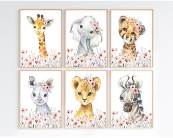 May include: Set of six framed watercolor prints featuring adorable safari animals: a giraffe, elephant, cheetah, rhino, lion, and zebra. Each animal wears a floral crown and is surrounded by pink flowers. The prints have a light brown frame.