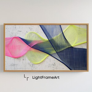 Puede incluir: Arte de pared abstracto con una pieza enmarcada de arte de cuerda con fondo blanco y cuerda de colores en rosa, amarillo y azul.