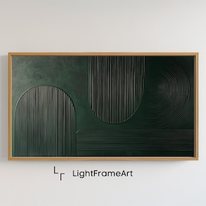 May include: A framed abstract art print with a dark green background and a geometric design of overlapping circles and lines. The frame is made of light wood.