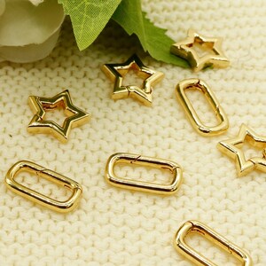 May include: Gold-toned metal star and rectangle shaped clasps. These clasps are ideal for attaching to bags, straps, or other accessories.