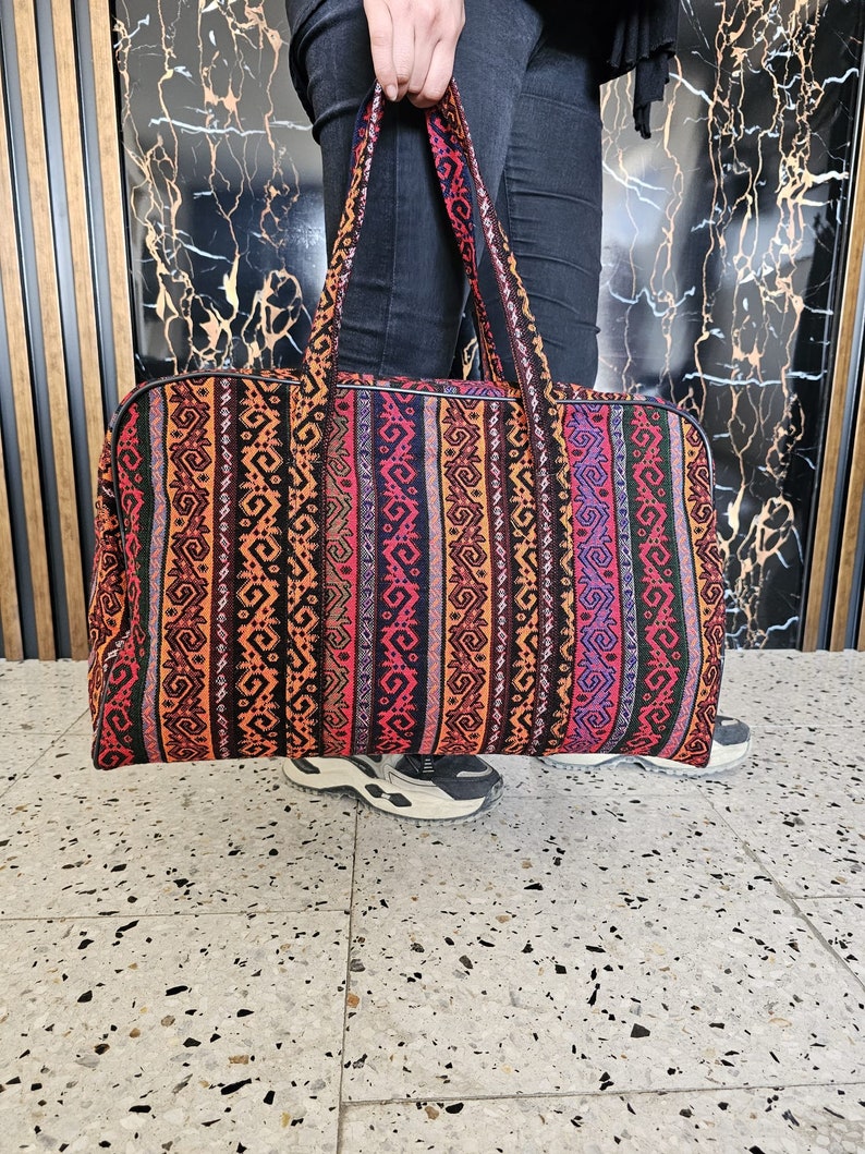 Close-up of the vibrant handwoven patterns on the Gaziantep rag suitcase, showcasing traditional Turkish designs.