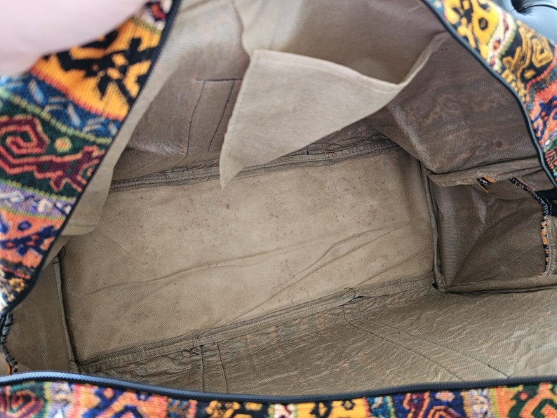 Open Gaziantep suitcase revealing the intricate interior and colorful textile craftsmanship.