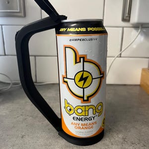 May include: A black can holder with a black handle is attached to a white and orange Bang Energy drink can. The can features the text "ANY MEANS POSSIBLE" and "ANY MEANS ORANGE". The can has a yellow lightning bolt design.