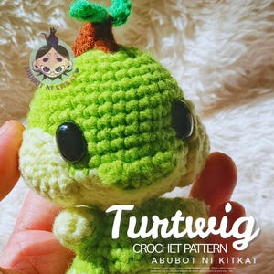 May include: A handmade crochet Turtwig plushie in shades of green and cream, with black button eyes and a brown and green leaf detail on top. The text "Turtwig" and "CROCHET PATTERN" are visible.