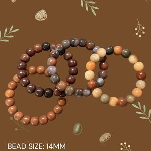 May include: Four beaded bracelets with 14mm beads in shades of brown, orange, and cream. The bracelets are arranged in a circular pattern against a brown background with decorative leaf and stone elements. The text "BEAD SIZE: 14MM" is visible.