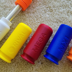 May include: A collection of colorful, 3D-printed accessories for a toy gun. The set includes white, yellow, red, blue, and orange components, each labeled with a different term. The accessories are designed to enhance the functionality of the toy gun.