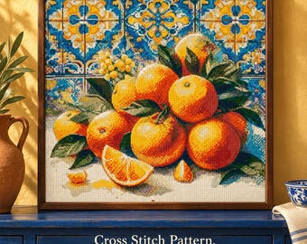 May include: A cross stitch pattern featuring a vibrant still life of oranges with green leaves against a blue and yellow tiled background. The image includes the text: Cross Stitch Pattern. Digital Download • PDF • XSD. The design is framed.
