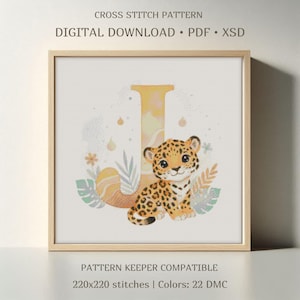 May include: A framed cross-stitch pattern featuring a cartoon leopard cub next to a large letter "J". The design includes floral and leaf accents in pastel colors. Text at the top reads "CROSS STITCH PATTERN" and "DIGITAL DOWNLOAD".