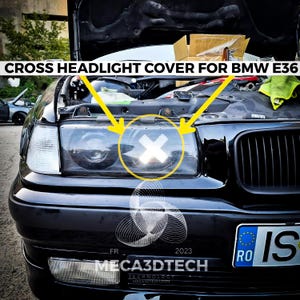 May include: Black BMW E36 car with the bonnet open, displaying a cross headlight cover. The text "CROSS HEADLIGHT COVER FOR BMW E36" is at the top. The car features a black front bumper and a license plate.