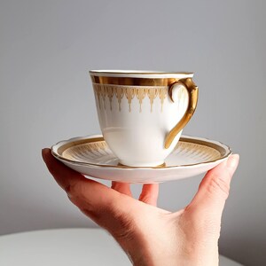 Art Nouveau English Elegant White and Gold Porcelain Tea Cup and Saucer Duo by New Chelsea Staffordshire circa 1910s