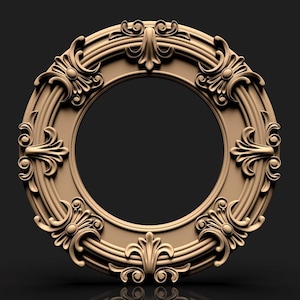May include: A detailed, circular, decorative frame in a warm, neutral tone. The frame features ornate, symmetrical scrollwork and floral designs around the perimeter. The inner circle is empty, creating a space for a picture or artwork. The frame is set against a dark background.