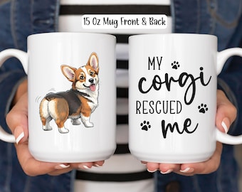 May include: White ceramic mug with a cartoon corgi illustration on one side and the text "MY corgi RESCUED me" on the other. The corgi is depicted in brown, black, and white. The mug is labeled "15 Oz Mug Front & Back".