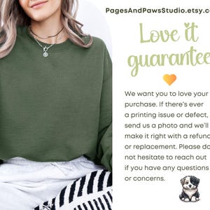 May include: An olive green sweatshirt with the text "Love it guarantee" and a guarantee statement. The Etsy shop name PagesAndPawsStudio.etsy.com is at the top. A small dog illustration is at the bottom.