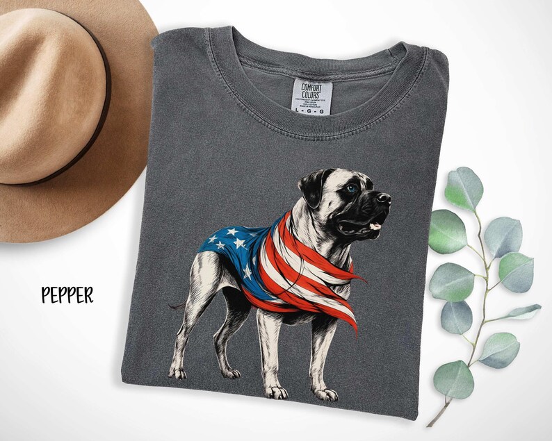 May include: A gray t-shirt with a graphic of a Bullmastiff dog wearing a red, white, and blue American flag bandana. The text "COMFORT COLORS" is on the tag.
