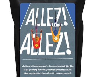 May include: Black coffee bag with a label featuring two cyclists racing on a gray road, with the words "ALLEZ!" in large white letters. The label also includes text about the coffee blend.