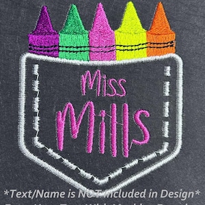 May include: Embroidered design of a pocket with crayons sticking out of the top and the text "Miss Mills" inside the pocket.