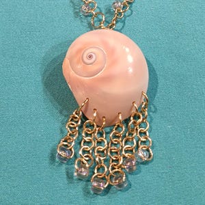 A custom designed Shark eye seashell pendant necklace.