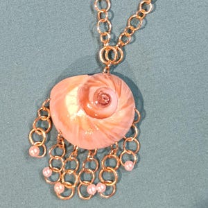 A custom designed Shark eye seashell pendant necklace.
