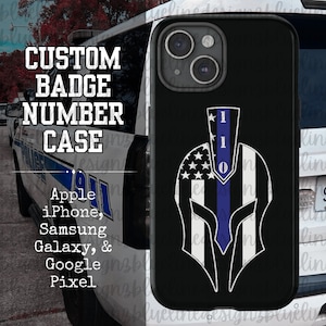 May include: A black phone case with a white and blue American flag design. The flag is in the shape of a Spartan helmet with a blue line down the center. The number "110" is printed on the helmet. The case is for Apple, iPhone, Samsung Galaxy, and Google Pixel phones.
