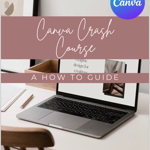 May include: A laptop computer on a white desk with a wooden chair and a wooden box. The laptop screen shows a website with the text "Graphic design for creatives". The text "Canva Crash Course A How To Guide" is displayed on a pink background above the laptop.