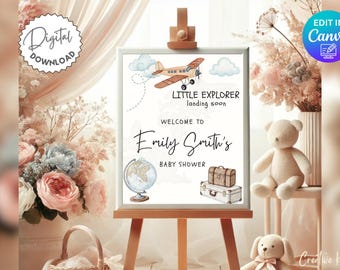 May include: A printable baby shower sign with a watercolor illustration of a plane, globe, and suitcases. The text reads "Little Explorer landing soon" and "Welcome to Emily Smith's Baby Shower".