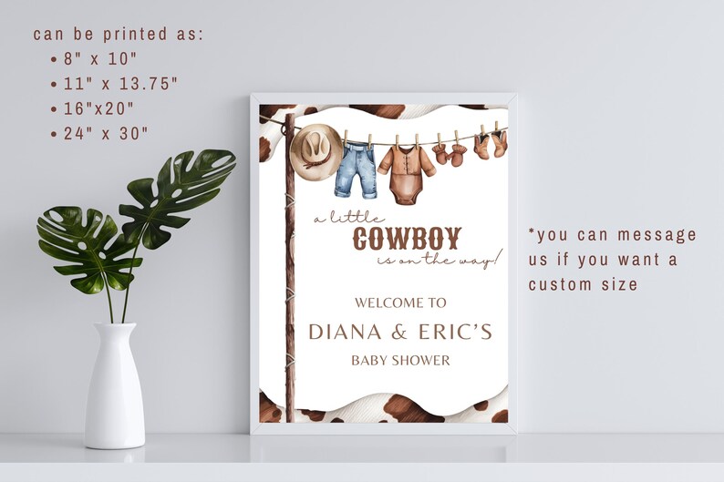 May include: A white framed printable sign with a brown cowhide background. The sign says "A little cowboy is on the way!" and "Welcome to Diana & Eric's Baby Shower". The sign also has a watercolor illustration of baby clothes hanging on a clothesline.