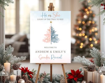 May include: A gender reveal sign on an easel. The sign reads "He or She, Light up the tree to see!" and "Welcome to Andrew & Emily's Gender Reveal." The tree design is split, with pink and blue halves.