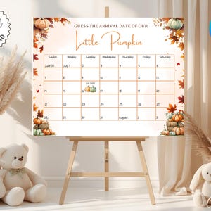 May include: A rectangular sign featuring the text "GUESS THE ARRIVAL DATE OF OUR Little Pumpkin" above a calendar grid. The design includes watercolour illustrations of orange and green pumpkins and autumn leaves in the corners.