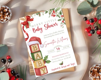 May include: A festive baby shower invitation with a Christmas theme. The invitation features the text "Merry Little Baby Shower" in red script, a Santa hat, and blocks spelling "BABY". The invitation is on a neutral background.