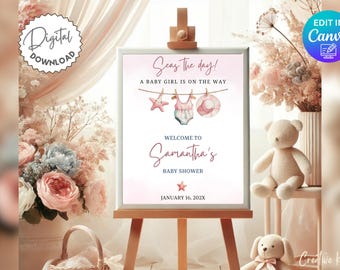 Op de afbeelding: Een babyborrelbord op een houten ezel. Het bord luidt "Seas the day! A baby girl is on the way." en verwelkomt gasten op Samantha's babyborrel. De illustratie toont een zeester, badpak en zonnehoed.