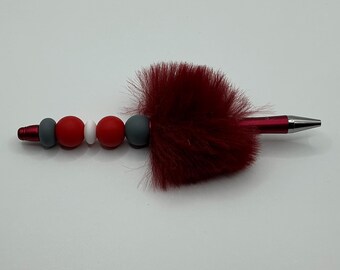 Ballpoint pen with red, gray & white silicone beads and red fluff.