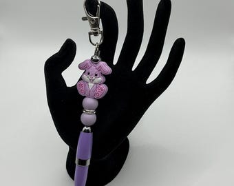 Silicone purple bunny rabbit pen keychain with purple glittering casing and purple silicone beads and rhinestone spacer.