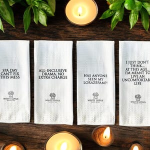 May include: Four white kitchen towels with black text and a logo. The towels have the following text: "Spa Day Can't Fix This Mess", "All-Inclusive Drama, No Extra Charge", "Has Anyone Seen My Lorazepam?!", and "I Just Don't Think... At This Age... I'm Meant To Live An Uncomfortable Life".