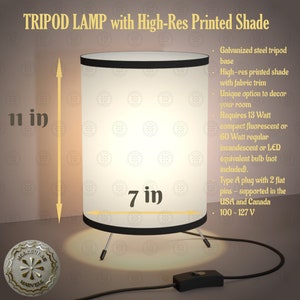 May include: A cylindrical tripod lamp with a high-resolution printed shade. The lamp has a galvanized steel tripod base and a fabric trim. The shade is 7 inches in diameter and 11 inches tall.