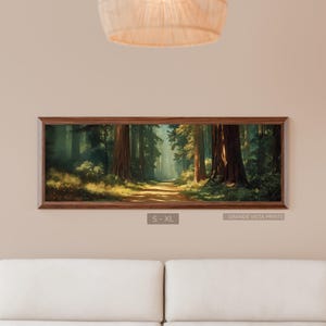 May include: A framed landscape print depicts a sunlit path winding through a redwood forest. The artwork features tall trees, a dirt path, and a soft, natural color palette. The frame is a warm brown color. The text "S - XL" and "GRANDE VISTA PRINTS" are visible.