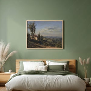 May include: A framed landscape painting depicts a Tuscan scene with a villa, cypress trees, and rolling hills under a blue sky. The artwork is displayed above a bed with white bedding and green pillows, creating a serene bedroom setting.