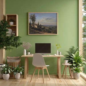 May include: A home office with a landscape painting, desk, and chair. The painting depicts a rural scene with buildings and trees. A computer monitor sits on the desk. Potted plants and a wooden floor complete the room.