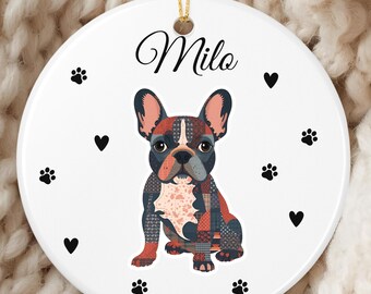 May include: A white ceramic ornament featuring a colorful illustration of a French Bulldog. The ornament is decorated with black paw prints and hearts. The name "Milo" is written in cursive at the top.